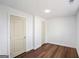 Cozy bedroom featuring hardwood floors and minimalist design, with two closet doors for ample storage at 2541 Peyton Woods Sw Trl, Atlanta, GA 30311