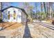 Charming two-story home with a brick exterior, mature trees, and a spacious driveway at 2541 Peyton Woods Sw Trl, Atlanta, GA 30311