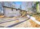 Two-story house featuring a garage and a wooden deck, complemented by mature trees and landscaping at 2541 Peyton Woods Sw Trl, Atlanta, GA 30311