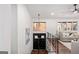 Bright foyer features modern lighting, black front door, wood floors, and stairway at 2541 Peyton Woods Sw Trl, Atlanta, GA 30311