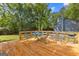 Wooden deck furnished with a metal table and chairs, perfect for outdoor relaxation and entertaining at 101 Jasmine Path, Peachtree City, GA 30269