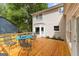 Inviting back deck with wooden flooring, a charming metal table, and views of the backyard at 101 Jasmine Path, Peachtree City, GA 30269