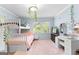 Charming bedroom featuring stylish decor, a cozy bunk bed, and a soft, inviting pink rug at 101 Jasmine Path, Peachtree City, GA 30269