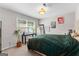 Bedroom featuring a plant, window, and bed with green blanket at 101 Jasmine Path, Peachtree City, GA 30269