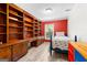 Cozy bedroom with custom built-in shelving, desk, and a brightly colored accent wall at 101 Jasmine Path, Peachtree City, GA 30269