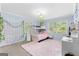 Bedroom featuring a bunk bed, carpet, windows, and hanging vines at 101 Jasmine Path, Peachtree City, GA 30269