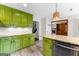 Kitchen featuring stylish green cabinets, granite countertops, stainless steel dishwasher and laminate floors at 101 Jasmine Path, Peachtree City, GA 30269