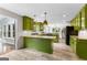 Spacious kitchen features green cabinets, granite countertops, stainless steel appliances and wood laminate flooring at 101 Jasmine Path, Peachtree City, GA 30269