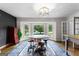 Bright living room featuring refinished hardwood floors, oversized windows, and an decorative lighting fixture at 101 Jasmine Path, Peachtree City, GA 30269
