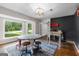 Bright living room with refinished hardwood floors, large windows, and an decorative lighting fixture at 101 Jasmine Path, Peachtree City, GA 30269
