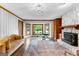 Relaxing living room featuring fireplace, wood paneling, large bay window, and refinished hardwood flooring at 101 Jasmine Path, Peachtree City, GA 30269