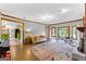 Relaxing living room featuring fireplace, wood paneling, large windows, and refinished hardwood flooring at 101 Jasmine Path, Peachtree City, GA 30269