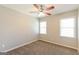 Bedroom featuring neutral walls, carpet, two windows, and ceiling fan at 1416 Emerald Pine Ct, Lawrenceville, GA 30043