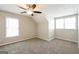 Cozy bedroom with natural light, neutral paint and carpet, plus a ceiling fan with light at 1416 Emerald Pine Ct, Lawrenceville, GA 30043