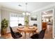 Elegant dining room featuring hardwood floors, a chandelier, and a view into the kitchen at 1416 Emerald Pine Ct, Lawrenceville, GA 30043