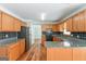 Spacious eat-in kitchen featuring stainless steel appliances and wood cabinets at 1416 Emerald Pine Ct, Lawrenceville, GA 30043