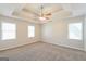 Spacious main bedroom with tray ceiling and three windows providing natural light at 1416 Emerald Pine Ct, Lawrenceville, GA 30043