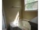 Bright bathroom with a jetted tub located next to a window at 5799 Eagles Feather Ln, Riverdale, GA 30274
