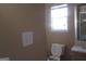 Standard bathroom with a toilet and a window at 5799 Eagles Feather Ln, Riverdale, GA 30274