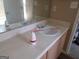 Bathroom vanity featuring a light countertop, wood cabinets, and a large mirror at 5799 Eagles Feather Ln, Riverdale, GA 30274