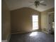 Spacious bedroom featuring neutral carpeting, vaulted ceiling, and natural light from the window at 5799 Eagles Feather Ln, Riverdale, GA 30274