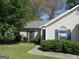 Charming home featuring blue shutters, a well-manicured lawn and inviting curb appeal at 5799 Eagles Feather Ln, Riverdale, GA 30274