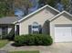 Inviting single-story home with light siding, dark shutters, and a well-maintained front yard at 5799 Eagles Feather Ln, Riverdale, GA 30274