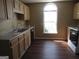 Bright eat-in kitchen with stainless steel appliances, dark wood floors and plenty of natural light at 5799 Eagles Feather Ln, Riverdale, GA 30274