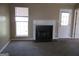 Cozy living room featuring a classic fireplace, neutral carpeting, and a bright window at 5799 Eagles Feather Ln, Riverdale, GA 30274