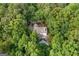 Aerial view of a beautiful home nestled among lush, mature trees, providing privacy and a serene setting at 1260 Heards Ferry Rd, Sandy Springs, GA 30328