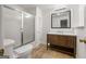 Bathroom featuring a white toilet, shower and dark wooden vanity at 1260 Heards Ferry Rd, Sandy Springs, GA 30328