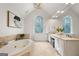 Bright bathroom featuring a soaking tub, double vanity, and arched windows that bring in natural light at 1260 Heards Ferry Rd, Sandy Springs, GA 30328