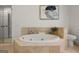 Bathroom featuring a soaking tub with tile surround at 1260 Heards Ferry Rd, Sandy Springs, GA 30328