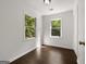 Bright bedroom with wood floors, neutral paint, and two windows offering an airy, relaxing space at 1260 Heards Ferry Rd, Sandy Springs, GA 30328