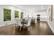 Bright open floor plan shows dining area with modern table and chairs, leading into updated kitchen and breakfast bar at 1260 Heards Ferry Rd, Sandy Springs, GA 30328