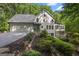 Charming home featuring a two-car garage, lush landscaping, and a sunroom surrounded by natural beauty at 1260 Heards Ferry Rd, Sandy Springs, GA 30328
