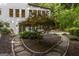 Rear view of a well-maintained home with surrounding garden and greenery in a tranquil setting at 1260 Heards Ferry Rd, Sandy Springs, GA 30328