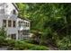 Rear view of a well-maintained home with surrounding garden and greenery in a tranquil setting at 1260 Heards Ferry Rd, Sandy Springs, GA 30328
