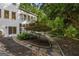 Rear view of a well-maintained home with surrounding garden and greenery in a tranquil setting at 1260 Heards Ferry Rd, Sandy Springs, GA 30328