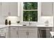 Bright kitchen with white cabinets and counters features stainless steel appliances and modern fixtures at 1260 Heards Ferry Rd, Sandy Springs, GA 30328