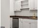 A charming kitchenette features white cabinetry, a mini-refrigerator, and a dark granite countertop at 1260 Heards Ferry Rd, Sandy Springs, GA 30328