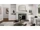 Living room featuring a fireplace, custom built-ins, and a view to the outside at 1260 Heards Ferry Rd, Sandy Springs, GA 30328