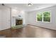 Bright living room featuring a decorative fireplace, hardwood floors, and natural light from large windows at 1260 Heards Ferry Rd, Sandy Springs, GA 30328