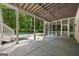 Covered patio overlooking the sparkling backyard pool with stairs and a screened-in porch at 1260 Heards Ferry Rd, Sandy Springs, GA 30328