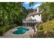 Inviting backyard with a private in-ground kidney-shaped pool and a beautiful white home exterior at 1260 Heards Ferry Rd, Sandy Springs, GA 30328