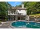 Inviting backyard with a private in-ground kidney-shaped pool and a beautiful white home exterior at 1260 Heards Ferry Rd, Sandy Springs, GA 30328