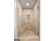Tiled shower featuring glass doors and a built-in bench at 1260 Heards Ferry Rd, Sandy Springs, GA 30328