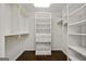 Walk-in closet with custom shelving and gold rods at 1260 Heards Ferry Rd, Sandy Springs, GA 30328