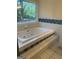 Relaxing bathroom featuring a deep soaking tub with jets and a large window view at 191 Lagrange St, Grantville, GA 30220