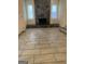 Open living room with a stone fireplace and light tile flooring, perfect for gatherings at 191 Lagrange St, Grantville, GA 30220